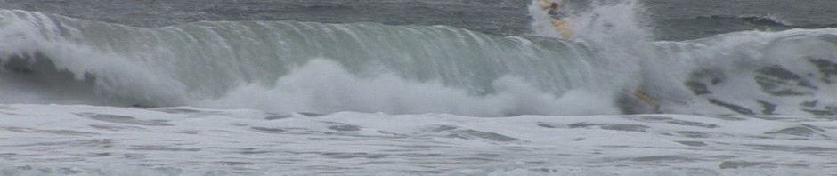 James Cowan punching through dumping surf in the Atlantis Spartan VI.